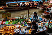 Thailand, Locals sell fruits, food and products at Damnoen Saduak floating market near Bangkok 